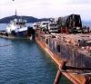 s_covered_with_Tarpaulin_on_Barge_at_Koh_Samui_with_Tugboat_in_the_back.jpg